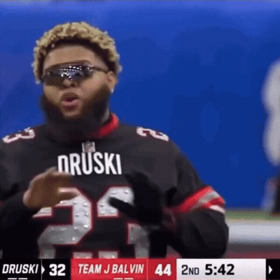 A Football Player Wearing Sunglasses And A Jersey That Says Druski GIF
