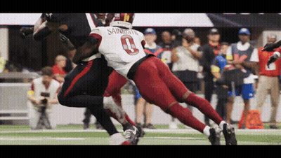 A Football Player Wearing The Number 0 Jersey Is Being Tackled By Another Player GIF