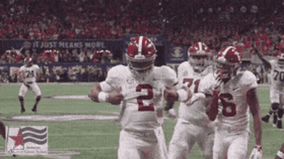 A Football Player Wearing The Number 2 Jersey Is Running With The Ball GIF