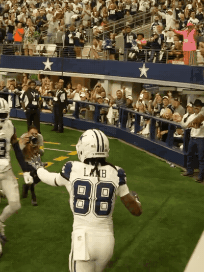 A Football Player Wearing The Number 88 Is Running On The Field GIF