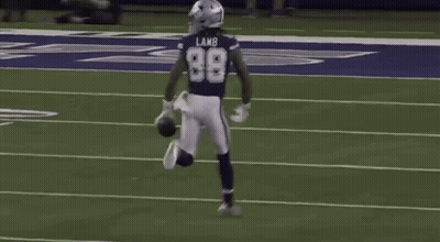 A Football Player Wearing The Number 98 Is Running On The Field . GIF