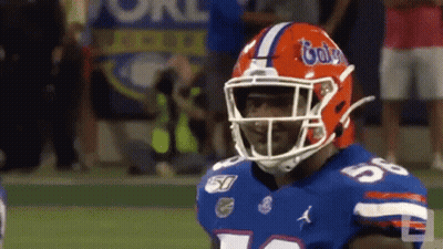 A Football Player With A Helmet That Says Gators On It GIF