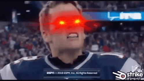 A Football Player With Red Eyes Is Standing In Front Of A Crowd At A Game . GIF