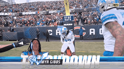 A Football Player With The Name Myr Gibbs On The Front GIF