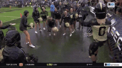 A Football Player With The Number 0 On The Back Of His Jersey Is Surrounded By Cheerleaders GIF