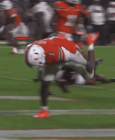 A Football Player With The Number 1 On His Jersey Is Doing A Handstand On The Field GIF