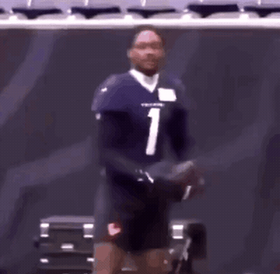 A Football Player With The Number 1 On His Jersey Is Standing In A Stadium GIF