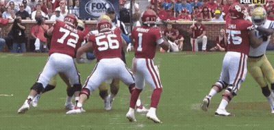 A Football Player With The Number 1 On His Jersey Is Surrounded By Other Players GIF