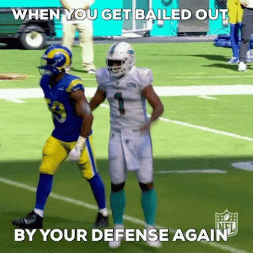 A Football Player With The Number 1 On His Jersey Stands Next To Another Player On The Field GIF