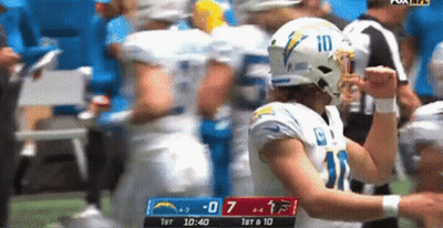 A Football Player With The Number 10 On His Helmet Celebrates GIF