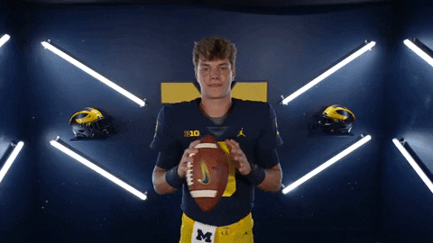 A Football Player With The Number 10 On His Jersey Holds A Football GIF