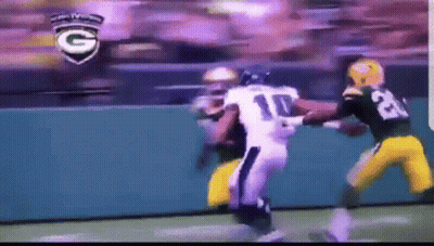 A Football Player With The Number 10 On His Jersey Is Being Tackled GIF