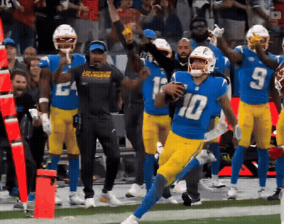 A Football Player With The Number 10 On His Jersey Runs With The Ball GIF