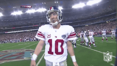 A Football Player With The Number 10 On His Jersey Stands On The Field GIF