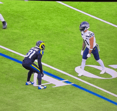 A Football Player With The Number 11 On His Jersey Is Jumping In The Air GIF