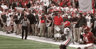 A Football Player With The Number 11 On His Jersey Is Running On The Field . GIF
