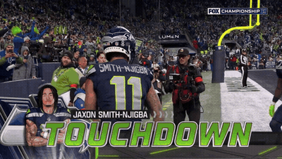 A Football Player With The Number 11 On His Jersey Stands On The Field GIF