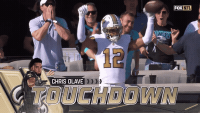 A Football Player With The Number 12 On His Jersey Celebrates GIF