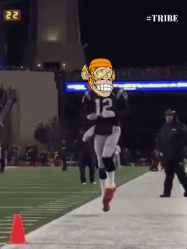 A Football Player With The Number 12 On His Jersey Is Jumping In The Air GIF