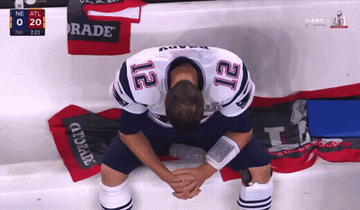 A Football Player With The Number 12 On His Jersey Is Kneeling Down GIF