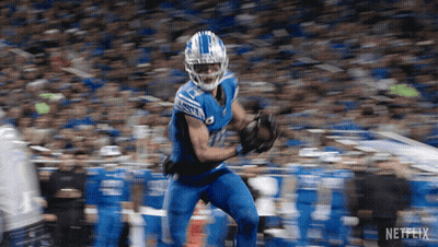 A Football Player With The Number 12 On His Jersey Is Running GIF
