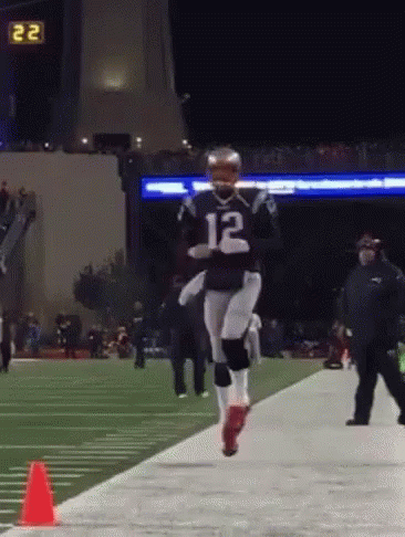 A Football Player With The Number 12 On Their Jersey GIF