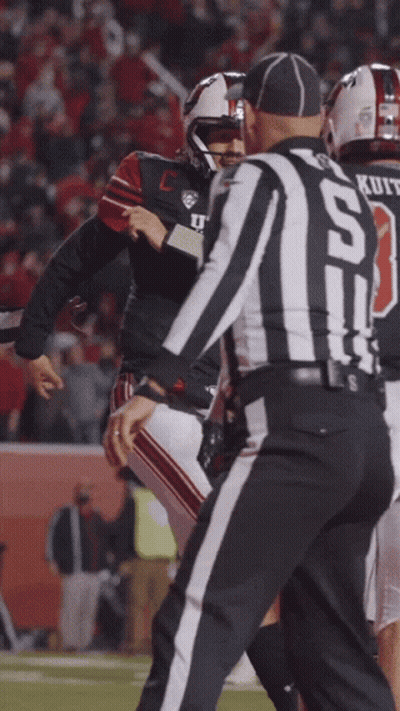A Football Player With The Number 13 On His Jersey Talks To A Referee GIF