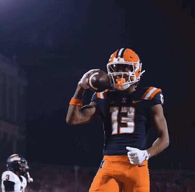 A Football Player With The Number 13 On His Jersey Throws A Football In The Air GIF