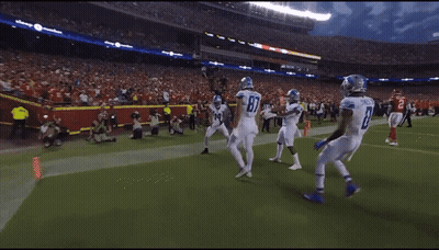 A Football Player With The Number 14 On His Jersey Celebrates With His Teammates GIF