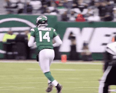 A Football Player With The Number 14 On His Jersey Is Running On The Field GIF