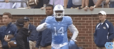 A Football Player With The Number 14 On His Jersey Is Running GIF