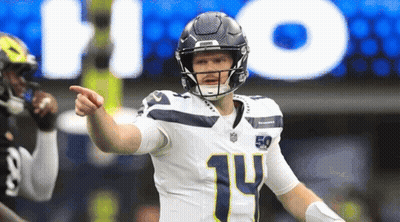 A Football Player With The Number 14 On His Jersey Points At Something GIF