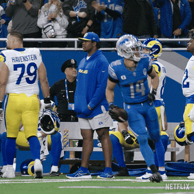 A Football Player With The Number 14 On His Jersey Runs On The Field GIF