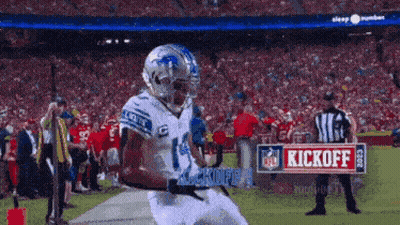 A Football Player With The Number 14 On His Jersey Runs On The Field GIF