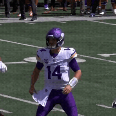 A Football Player With The Number 14 On His Jersey Stands Next To Another Player GIF