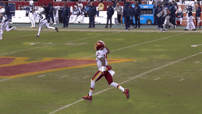 A Football Player With The Number 14 On His Jersey Stands On The Field GIF