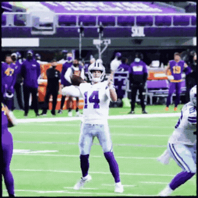 A Football Player With The Number 14 On His Jersey Throws A Pass GIF