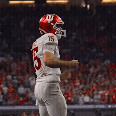 A Football Player With The Number 15 On His Jersey Is Dancing GIF