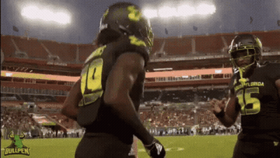 A Football Player With The Number 15 On His Jersey Is Running On The Field GIF