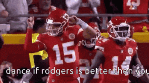 A Football Player With The Number 15 On His Jersey Is Standing Next To Another Player . GIF