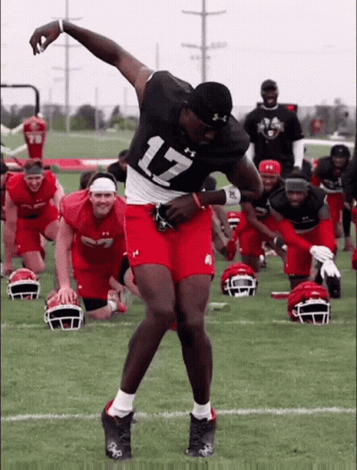 A Football Player With The Number 17 On His Jersey Is Dancing On The Field GIF