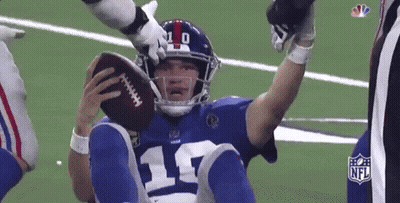 A Football Player With The Number 17 On His Jersey Is Holding A Football GIF