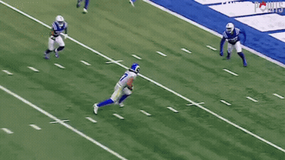A Football Player With The Number 17 On His Jersey Is Running On The Field . GIF