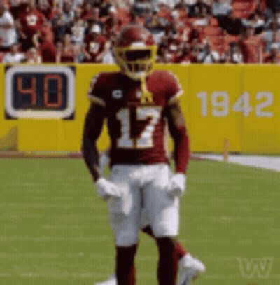 A Football Player With The Number 17 On His Jersey Stands On A Field GIF