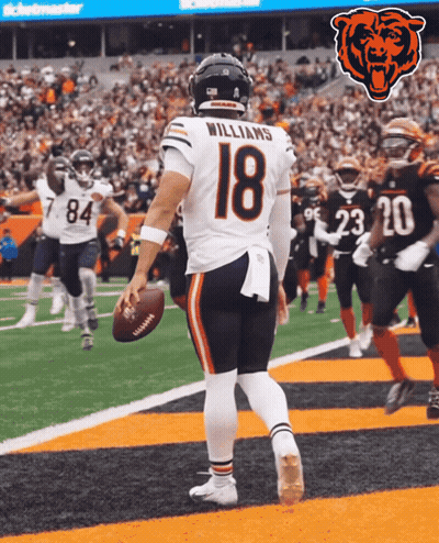 A Football Player With The Number 18 On His Jersey Stands On The Field GIF