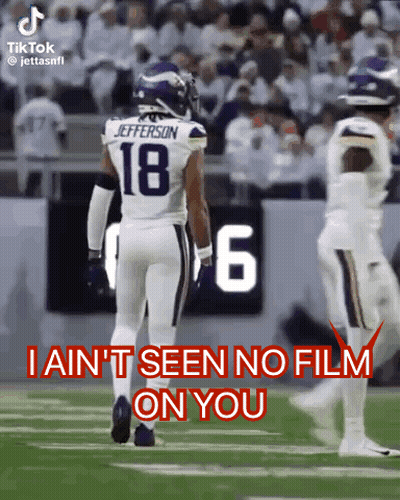A Football Player With The Number 18 On His Jersey Walks On The Field . GIF