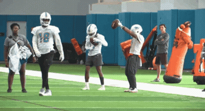 A Football Player With The Number 18 On The Back Of His Helmet GIF