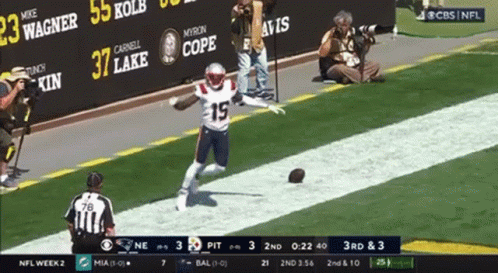 A Football Player With The Number 19 On His Jersey Is Running On The Field GIF