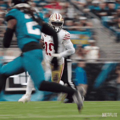 A Football Player With The Number 19 On His Jersey Is Running With The Ball GIF