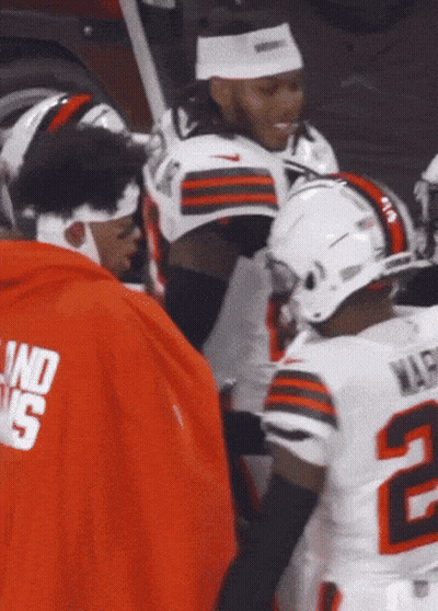 A Football Player With The Number 2 On His Jersey Is Talking To Another Player GIF